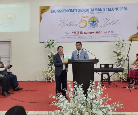 Tongpang Ozüküm, MLA & Advisor for Water Resources, unveiling the Golden Jubilee souvenir during the celebration of Mongsenyimti Senso Tamang Telongjem (MSTT), Mokokchung, held at WATEM on October 2. (Morung Photo)