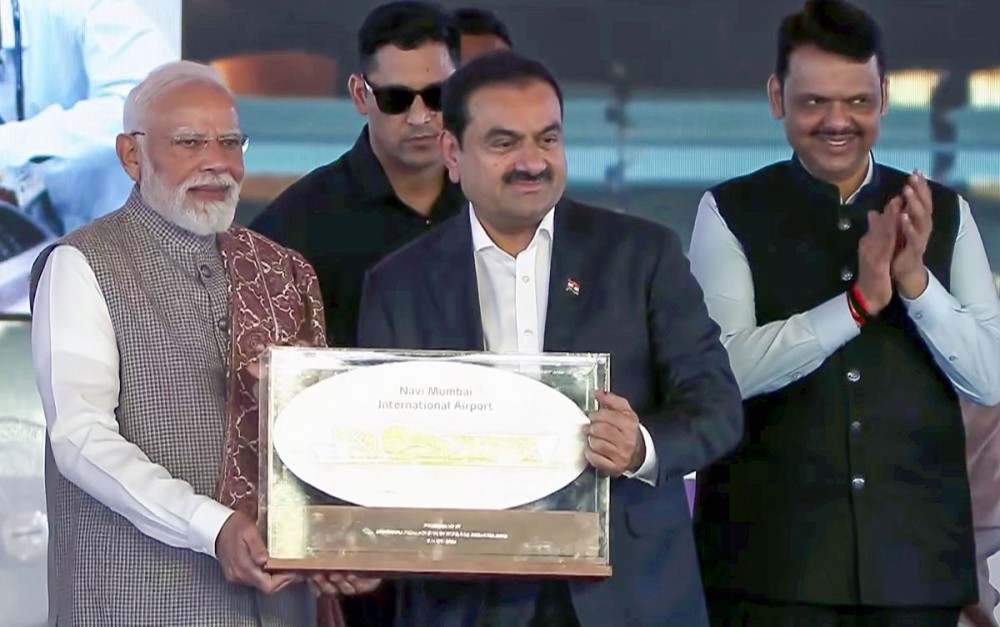 Mumbai: Prime Minister Narendra Modi being felicitated by Adani Group Chairman Gautam Adani during the inauguration of Phase 1 of the Navi Mumbai International Airport in Mumbai, Wednesday, October 08, 2025. (Photo: IANS/Video Grab)