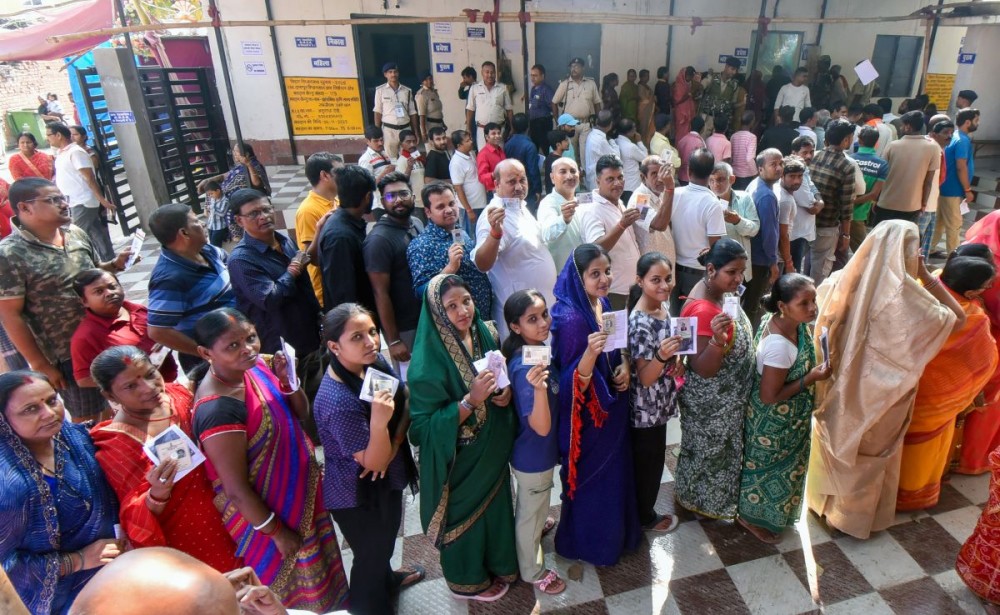 Patna: Voters stand in a queue holding their voter ID cards to cast their votes during the first phase of the Bihar Assembly elections in Patna on Thursday, November 6, 2025. (Photo: IANS)