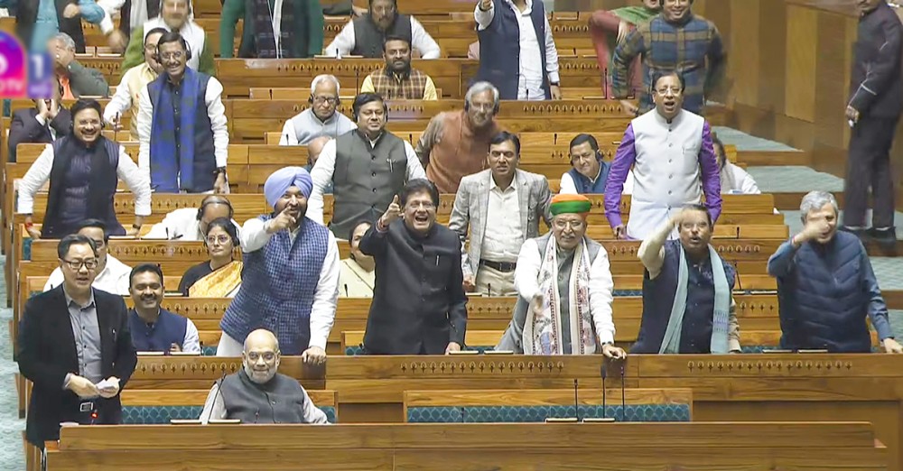 Union Home Minister Amit Shah and other MPs in the Lok Sabha during the winter session of Parliament in New Delhi on Wednesday, December 10, 2025. (Photo: IANS/Video Grab/Sansad TV)