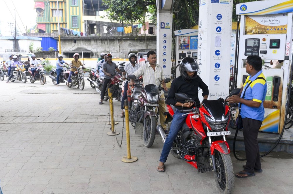 Commuters queue up at a petrol pump after petrol and diesel prices were hiked by Rs 3 per litre each, in Balurghat of Dakshin Dinajpur district, West Bengal on May 15, 2026. (IANS Photo)