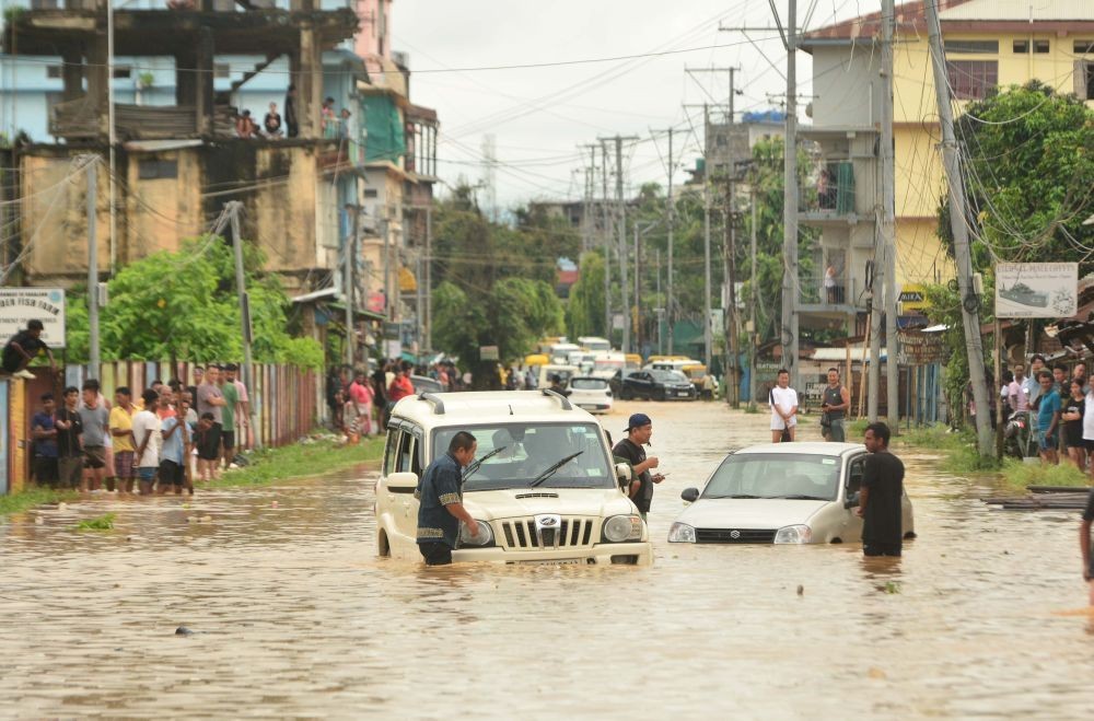 Two vehicles stranded on a flooded road following heavy rainfall in Dimapur on July 6, 2025. Several localities in Dimapur and adjoining districts were left inundated after incessant rain between July 5 and 6. (File Photo Courtesy by Caisii Mao)