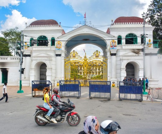 Vehicles pass by the premises of Singha Durbar, which houses the Prime Minister’s Office and other ministries, after the curfew and prohibitory order were lifted following the September 8 violence during Gen-Z’s anti-corruption protest that led to regime change, in Kathmandu, Nepal on September 13, 2025. (IANS File Photo)