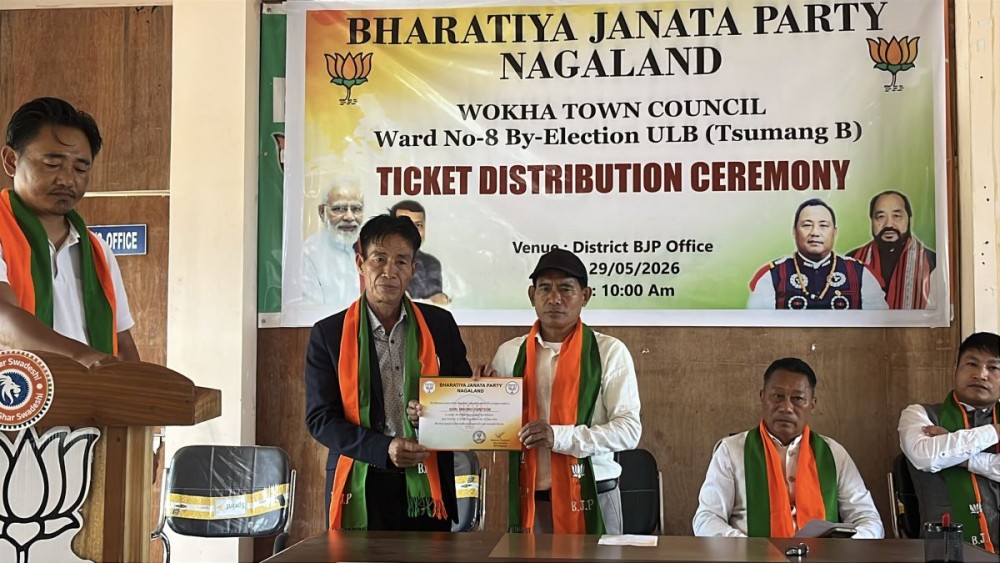 Intending candidate Mhomo Humtsoe, receives the party ticket from Rhanbemo Odyuo, President of BJP Wokha during the ticket distribution programme held at its office in Wokha on May 29. (Morung photo)