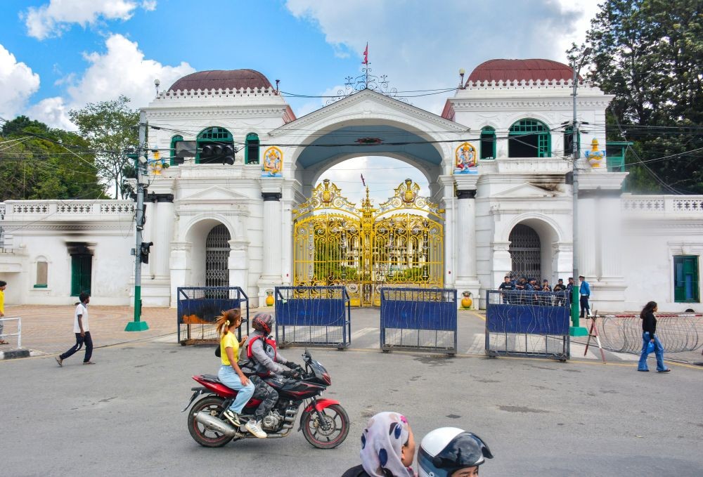 Vehicles pass by the premises of Singha Durbar, which houses the Prime Minister’s Office and other ministries, after the curfew and prohibitory order were lifted following the September 8 violence during Gen-Z’s anti-corruption protest that led to regime change, in Kathmandu, Nepal on September 13, 2025. (IANS File Photo)