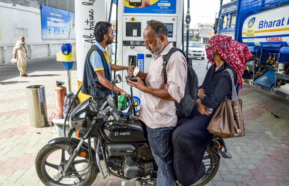 Customers refuel their vehicles at a petrol pump after petrol and diesel prices were hiked in the second increase within a week, in Amritsar on May 19. (IANS Photo)