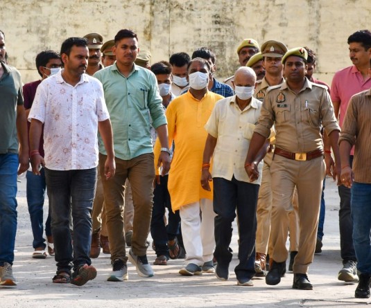 Ayodhya: Police escort the accused in the alleged Ram Temple donation embezzlement case to jail after a local court remanded them to judicial custody, in Ayodhya district of Uttar Pradesh on Friday, June 26, 2026. The accused are scheduled to be produced before the court again on Monday. (Photo: IANS)