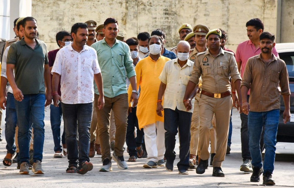 Ayodhya: Police escort the accused in the alleged Ram Temple donation embezzlement case to jail after a local court remanded them to judicial custody, in Ayodhya district of Uttar Pradesh on Friday, June 26, 2026. The accused are scheduled to be produced before the court again on Monday. (Photo: IANS)