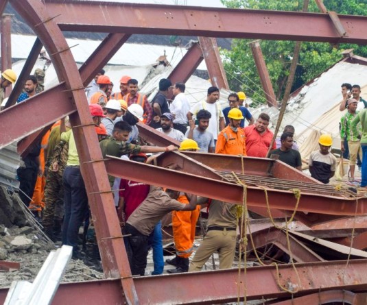 Rescue personnel carry out operations after the roof of an under-construction warehouse collapsed in the Taratala area of Kolkata on June 24, 2026. Several people were feared trapped under the debris as emergency teams launched rescue efforts at the site. (IANS Photo)