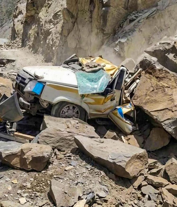 A damaged taxi lies amid boulders and debris after being struck by a landslide near Kadu Nala on the Udaipur-Killar road, killing 13 people, in Lahaul-Spiti district of Himachal Pradesh on July 24, 2026. (IANS Photo)