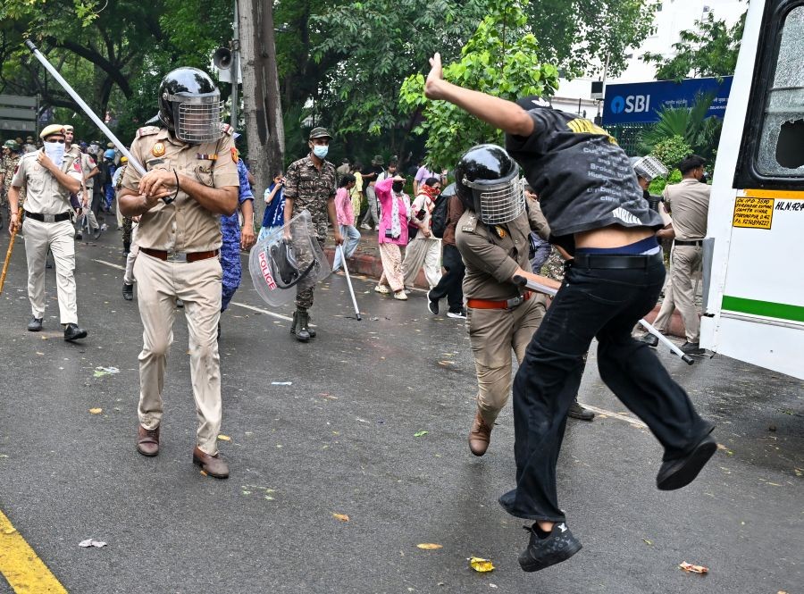 Police personnel baton-charge a supporter of the Cockroach Janta Party (CJP) during their ‘Chalo Sansad’ protest march towards Parliament near Jantar Mantar in New Delhi on July 20, 2026. ( IANS Photo)