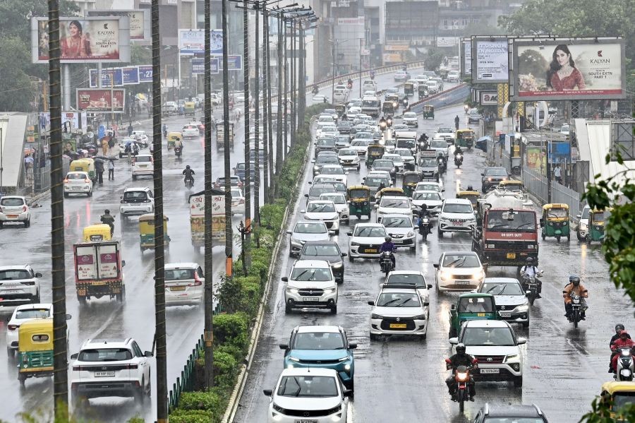 Traffic moves along a rain-soaked arterial road during monsoon showers in New Delhi on July 9, 2026. (IANS Photo)