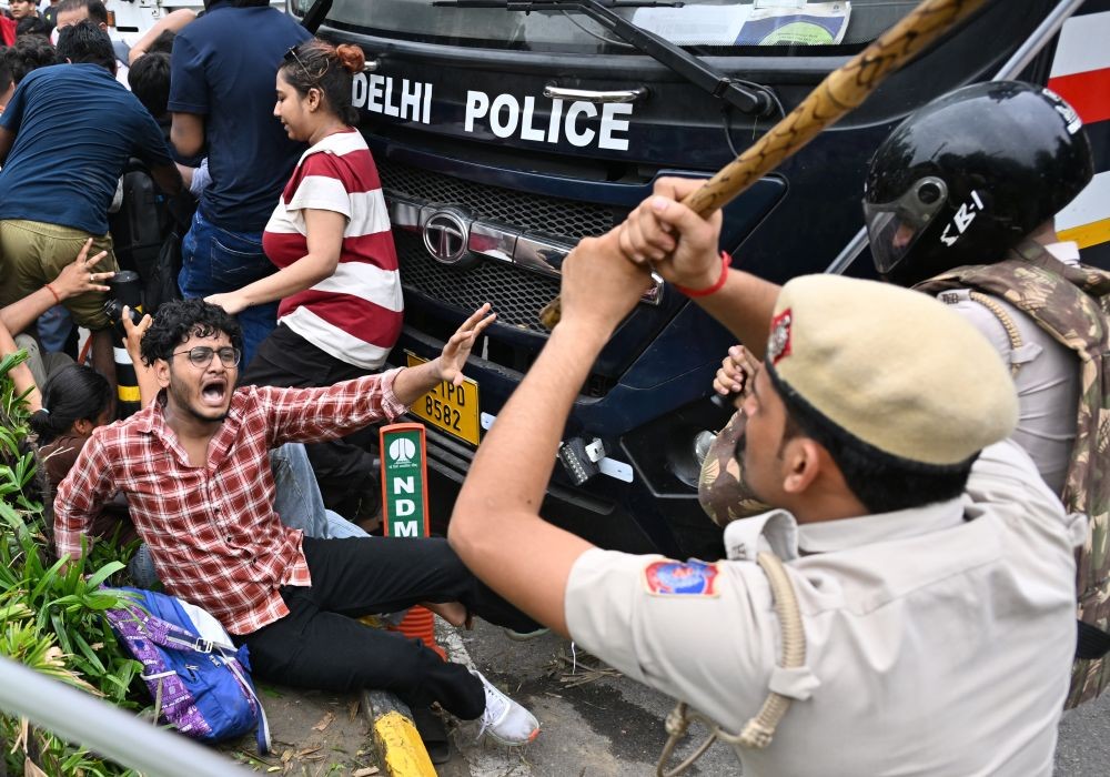 A policeman baton-charges a supporter of the Cockroach Janta Party (CJP) during the ‘Chalo Sansad’ protest march towards Parliament near Jantar Mantar in New Delhi on July 20, 2026. (IANS Photo)