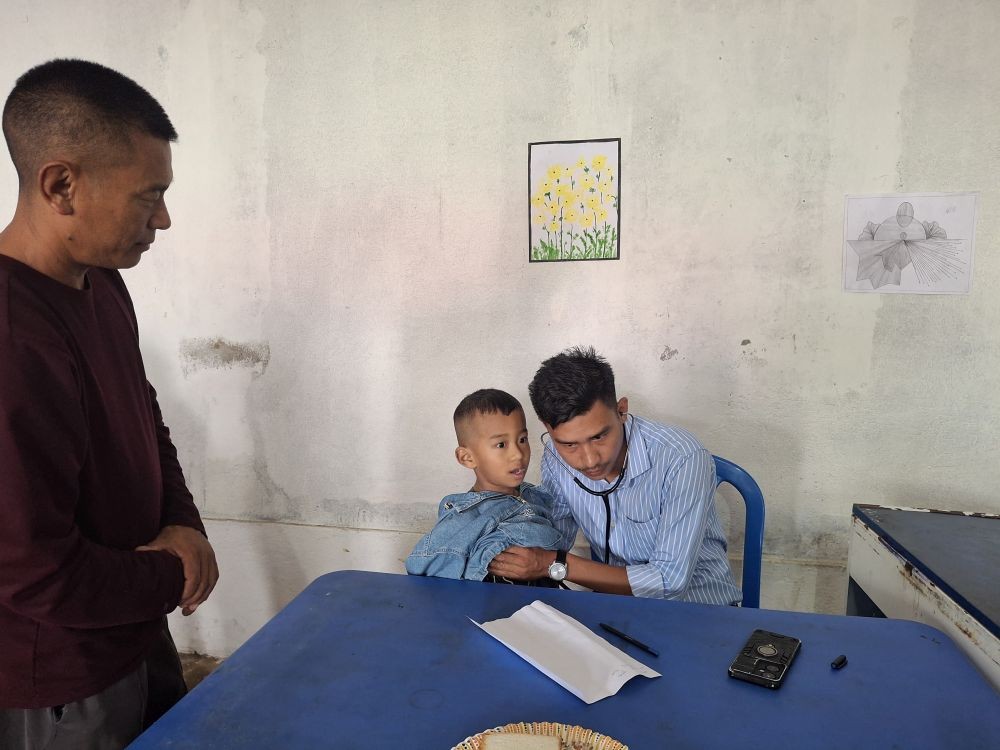 A medical officer screens a young beneficiary during the health camp at Wokha Village on July 18.