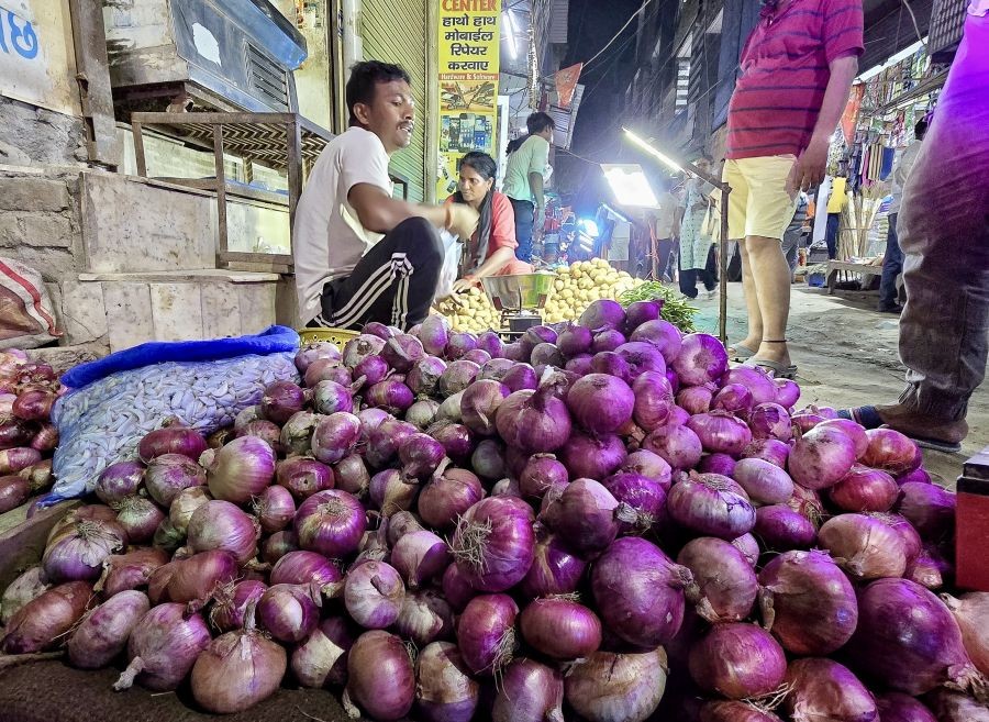 Vendors sell onion at a vegetable market in New Delhi. (IANS File Photo)
