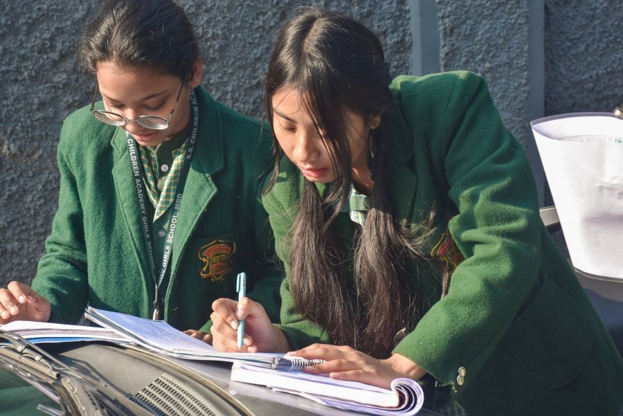 Students go through their notes outside an examination centre before appearing for the Central Board of Secondary Education (CBSE) Class XII exam in Moradabad on February 20, 2026. (IANS File Photo)