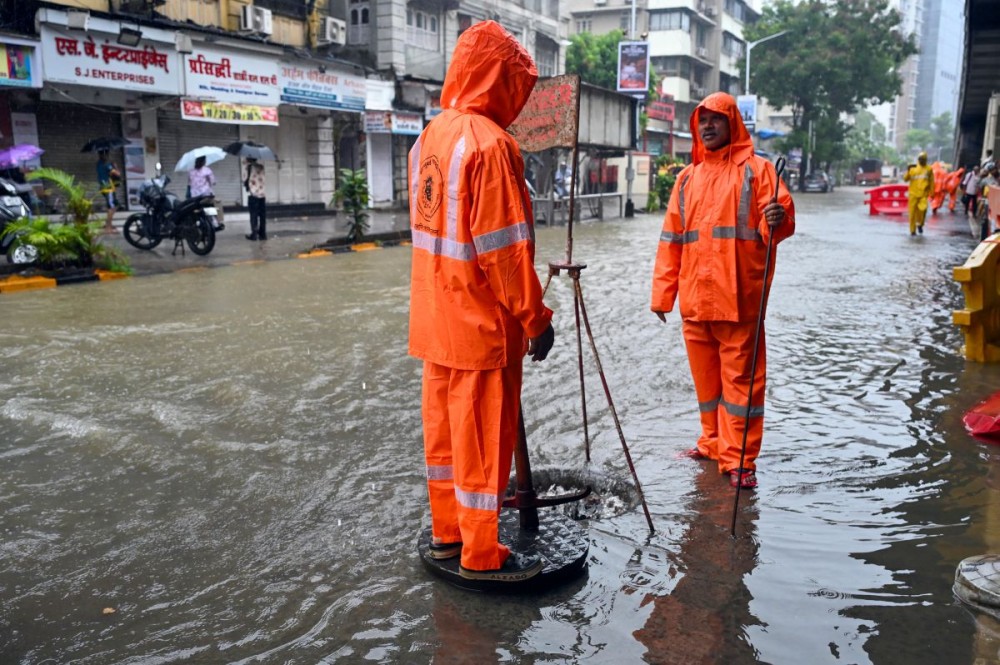 Mumbai: Brihanmumbai Municipal Corporation (BMC) workers clear a blocked drain during heavy monsoon rainfall in Mumbai, Maharashtra, on Thursday, July 2, 2026. (IANS)