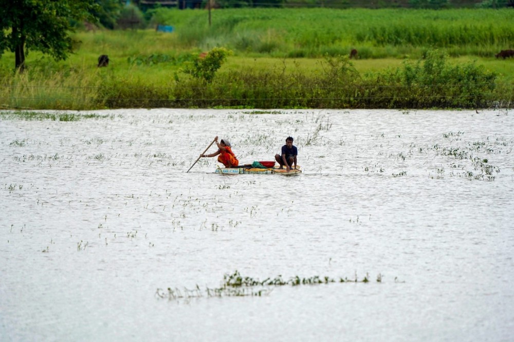 Morigaon: People commute on makeshift rafts crafted from discarded materials as floodwaters inundate parts of Morigaon district of Assam on Monday, July 20, 2026. (Photo: IANS)