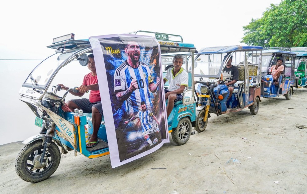 Morigaon: An e-rickshaw driver displays a poster of football icon Lionel Messi on his vehicle as FIFA World Cup fever grips rural areas of Morigaon district, Assam, on Saturday, July 18, 2026. (Photo: IANS)