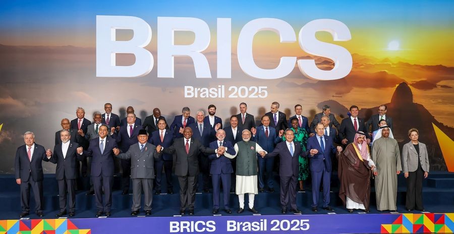 Prime Minister Narendra Modi joins hands with Brazilian President Luiz Inacio Lula da Silva, China’s Premier Li Qiang and others during a group photo at the 17th annual BRICS summit, in Rio de Janeiro on July 7, 2025. (IANS/PMO File Photo)