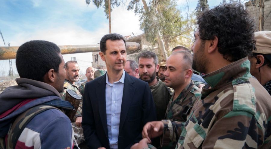 Syrian President Bashar al-Assad (C) is surrounded by soldiers of Syrian army as he visits a frontline area in Damascus' Eastern Ghouta area, Syria, on March 18, 2018.  (IANS File Photo)