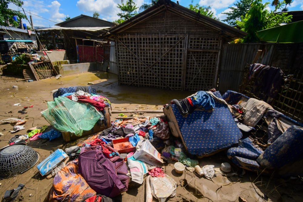 Damaged belongings of residents lie on the ground following flash floods triggered by heavy rain at Nepalikhuti village in Sivasagar district of Assam, on August 8, 2026. (IANS File Photo)
