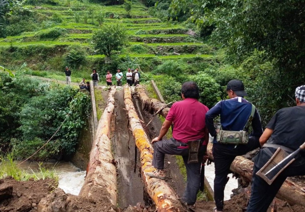 The vital bridge on the Noklak–Panso route collapsed on July 19, after heavy rain in the upstream area, snapping the road link for surrounding villages.  (Morung Photo)