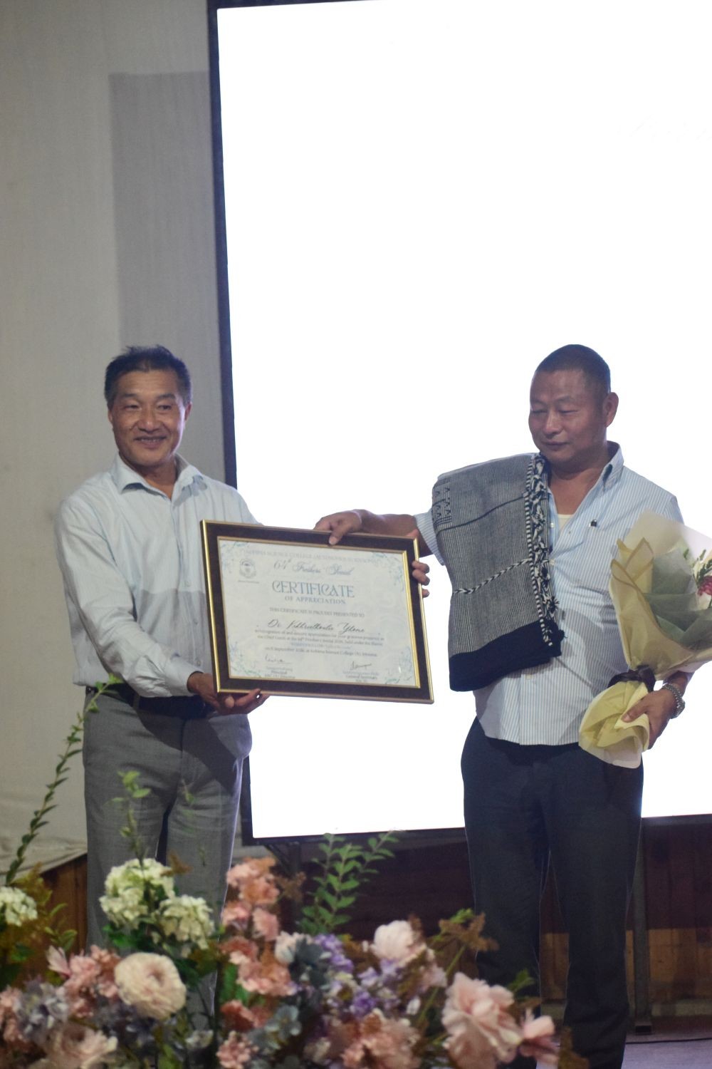 Advisor Dr Yhome receives a certificate during the 64th Freshers' Social of Kohima Science College, Jotsoma (KSCJ), held at the college auditorium on September 11.