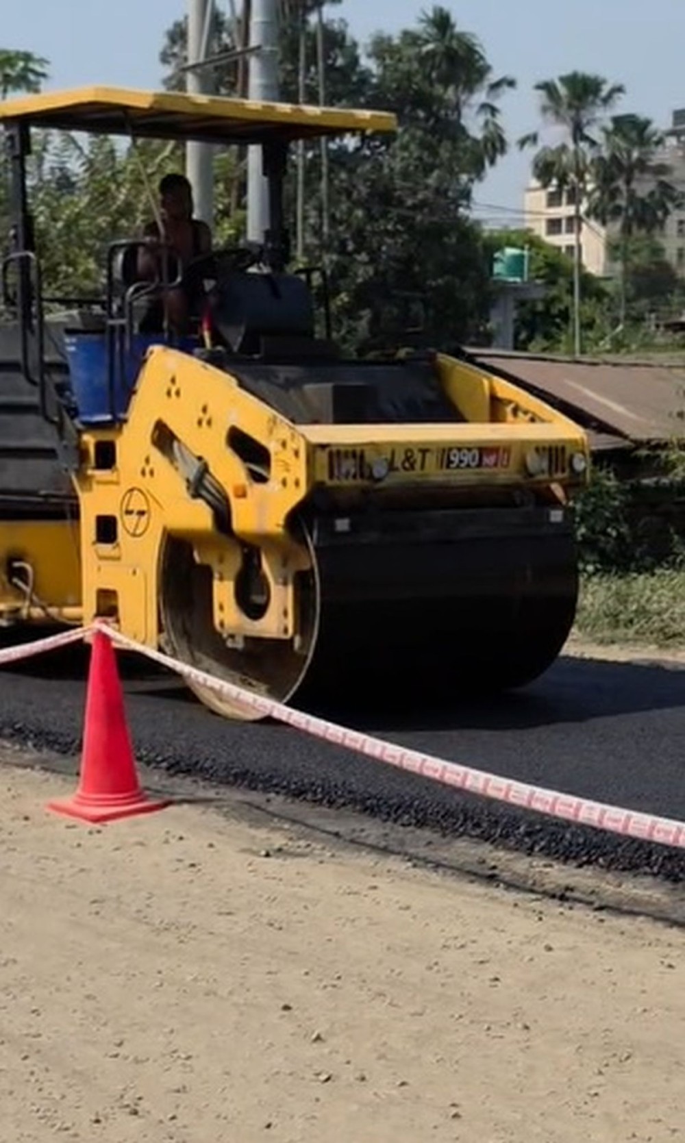 A road roller levels fresh asphalt during construction work on the road stretch in question. (Photo Courtesy: ETDC)