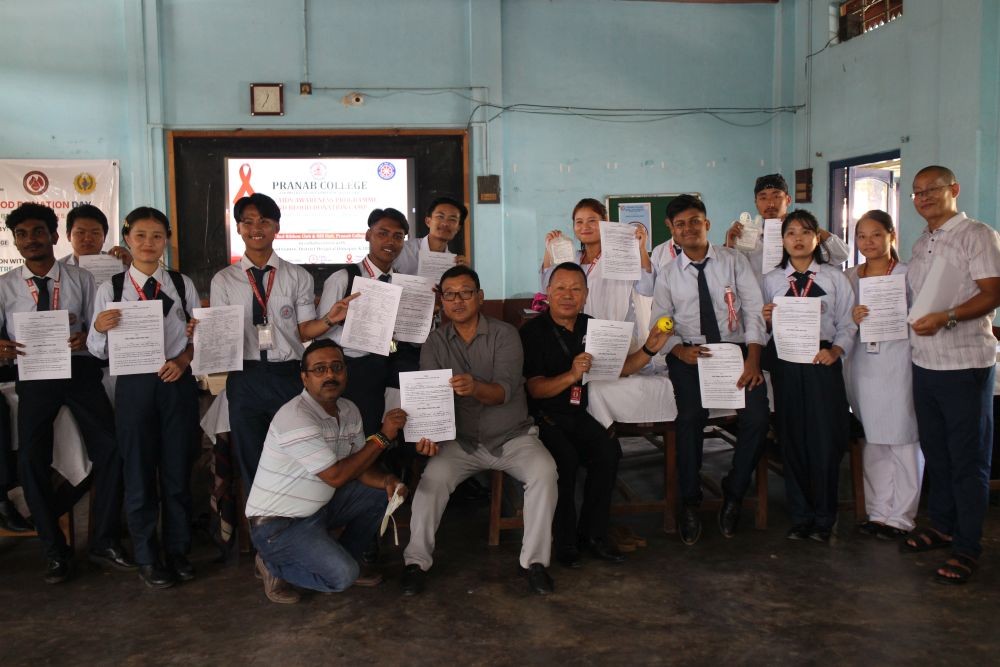 Faculty members and students of Pranab College display documents during an awareness programme organised by the Red Ribbon Club and NSS unit on September 25.