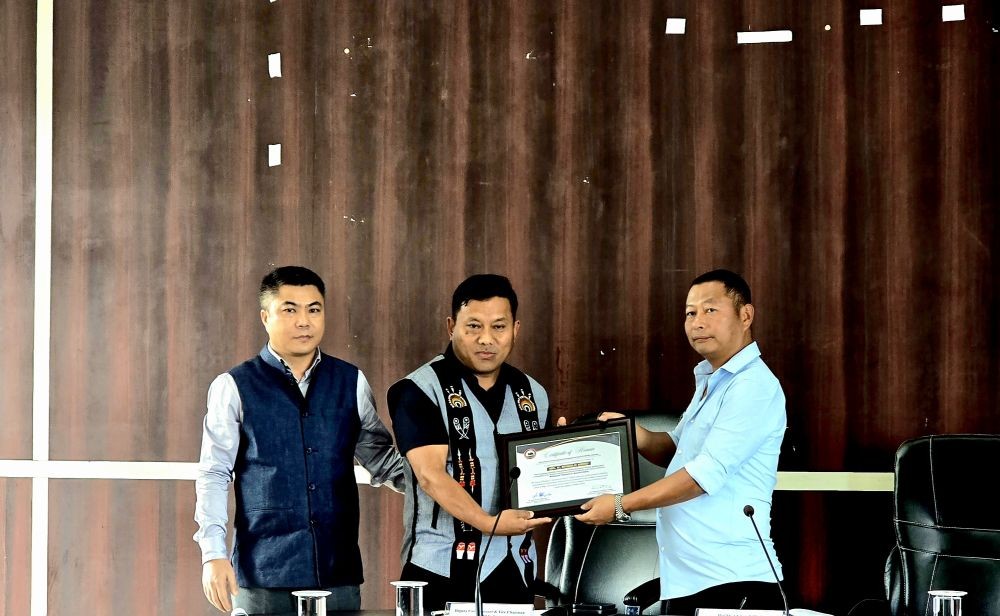 National Teachers’ Award 2026 recipient Ronald Meru, teacher at GHSS, Sechü-Zubza, being felicitated by Advisor Dr Kekhrielhoulie Yhome and DC Kohima B Henok Buchem during the DPDB meeting in Kohima on September 22. (DIPR Photo)
