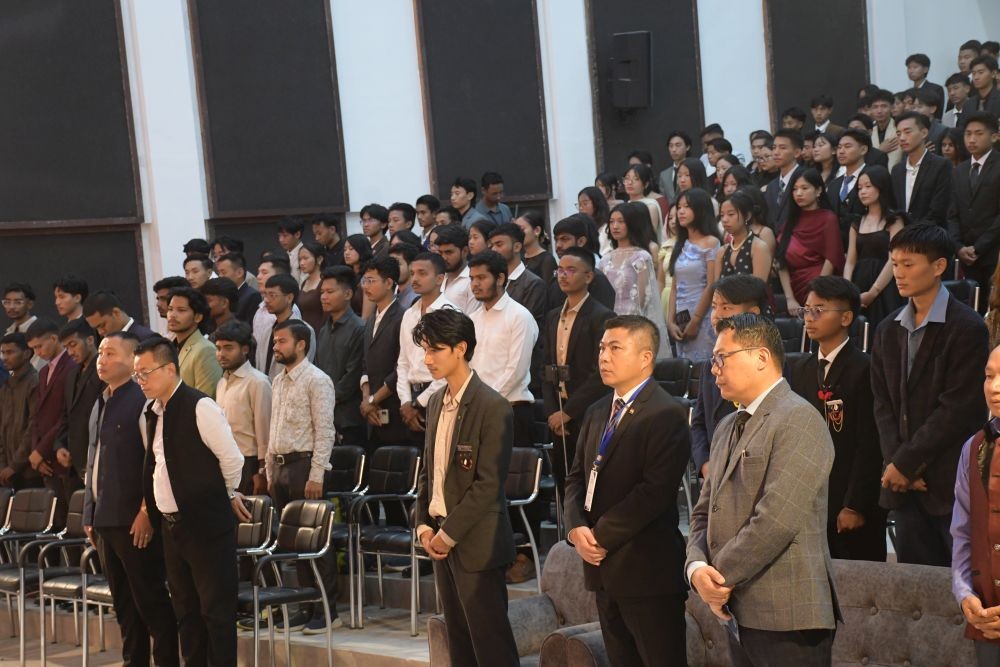 Dignitaries, faculty, and students standing during the 33rd Freshers’ Meet of the Nagaland University Students’ Union, Kohima Campus, held at AGOK Badze, Meriema.