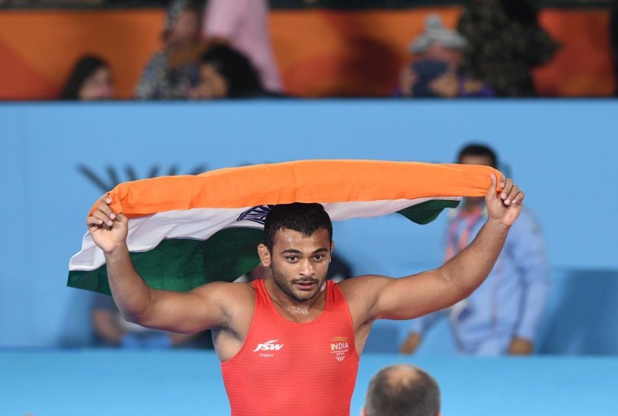 India's Deepak Punia hold Indian flag after winning against Pakistan's Muhammed Inam in the final of the Men's freestyle 86kg category event in the Commonwealth games in Birmingham, on August 05, 2022.(Photo: Subir Halder/IANS)