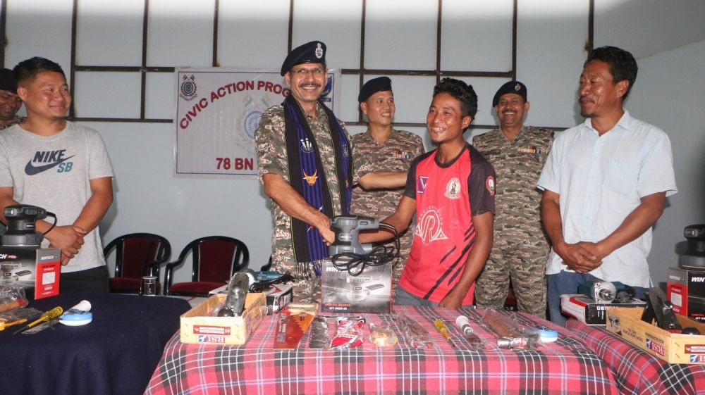 CRPF officer hands over the tools to a beneficiaries during a Civic Action Programme at Sechüma village in Kohima district on October 23.