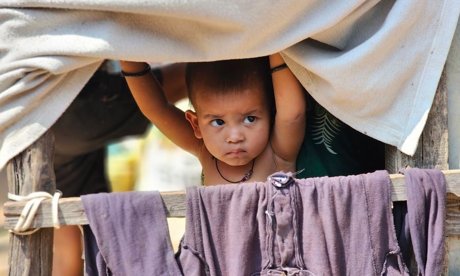 A Rohingya child looks out from a makeshift shelter amid concerns over possible eviction following administrative action and verification of foreign nationals, in Jammu, Jammu and Kashmir, on September 16, 2026. (Photo: IANS)