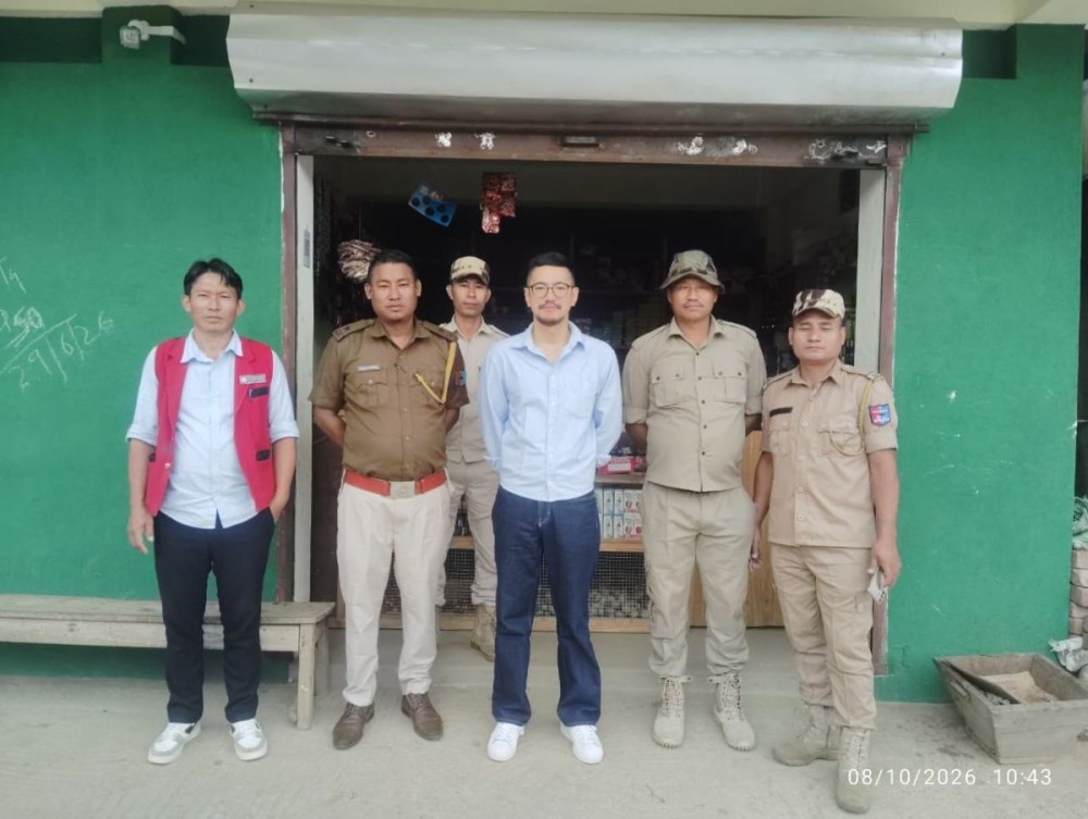Officials pose for a photo along with the seized tobacco products in Pughoboto on October 8.