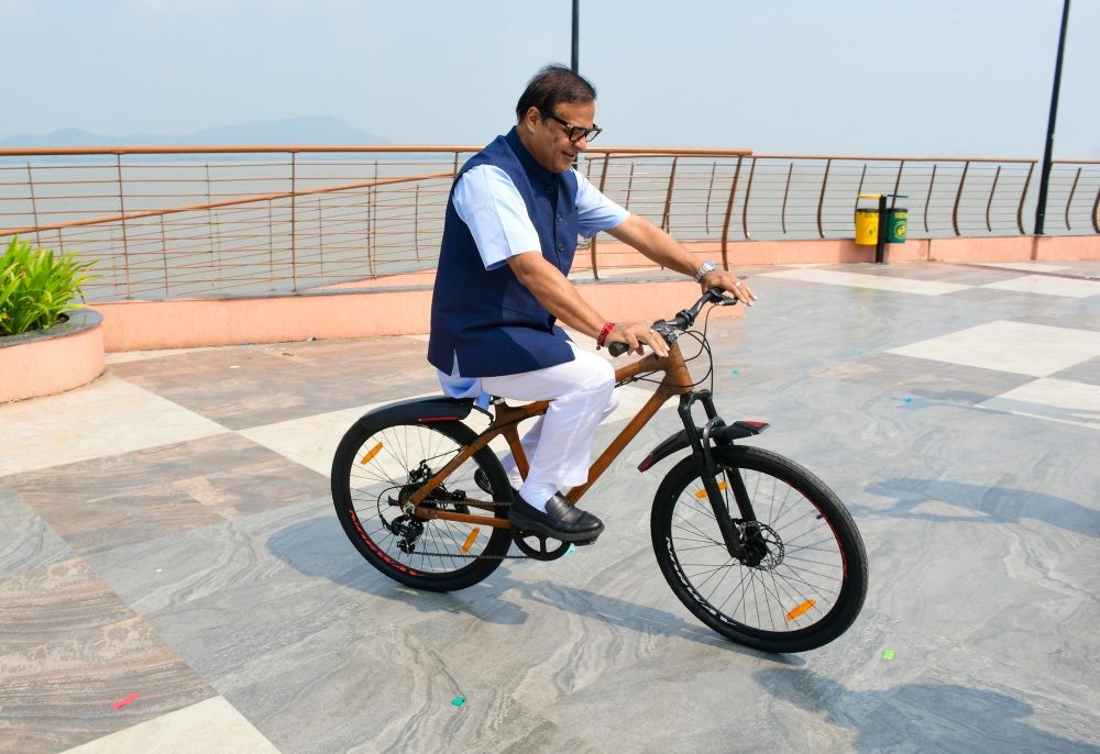 Guwahati: Assam Chief Minister Himanta Biswa Sarma rides a bicycle during the launch of bamboo bicycles as part of a sustainable mobility initiative at Guwahati Riverfront in Uzan Bazar, Guwahati, Friday, October 2, 2026. (Photo: IANS)
