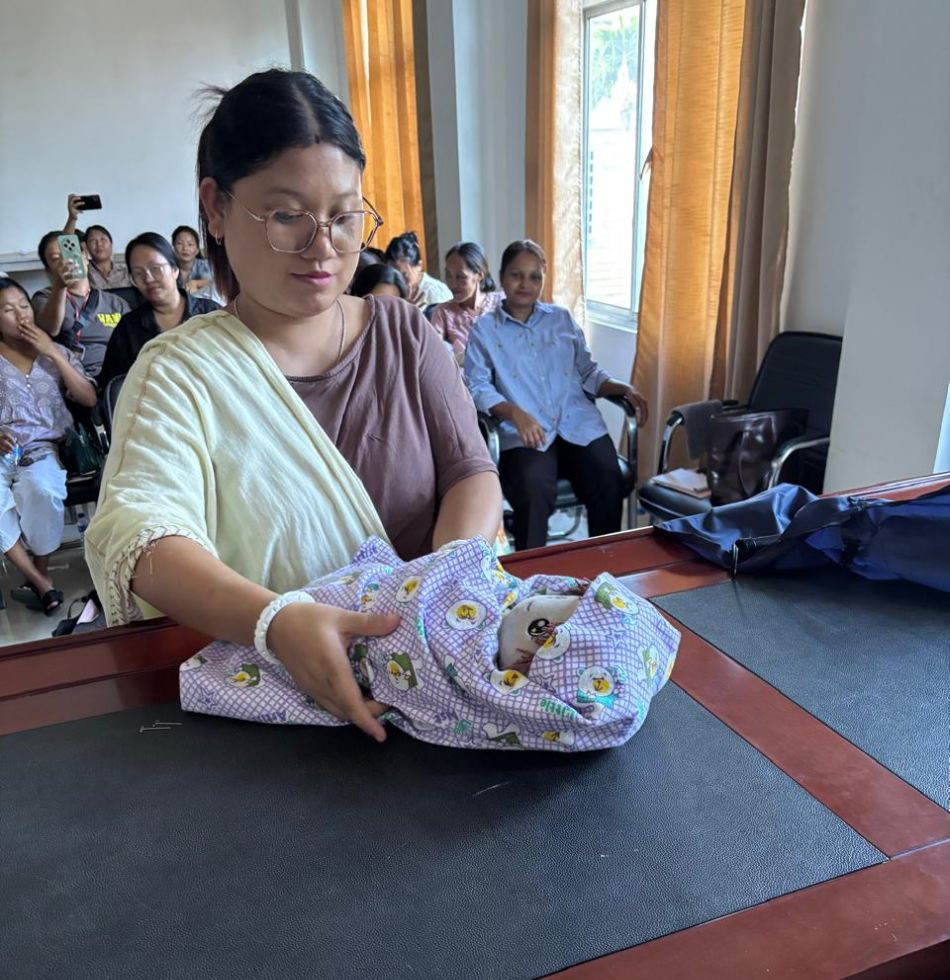 An ASHA trainee learns proper technique of wrapping a newborn during the induction training programme held the CMO’s Office, Dimapur from October 8 to 14. ((Photo Courtesy:  CMO Dimapur)