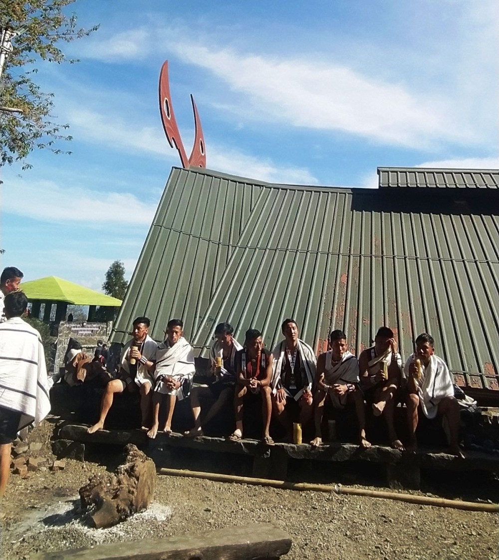 A group of young Naga men are basking in the pleasant warmth of the winter morning sun at Kisama Heritage Village. (Morung file Photo)