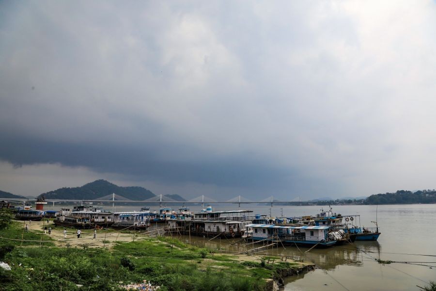 A view of the banks of the Brahmaputra River as dark rain clouds loom over the city skyline, in Guwahati on April 26, 2026. (Photo: IANS)