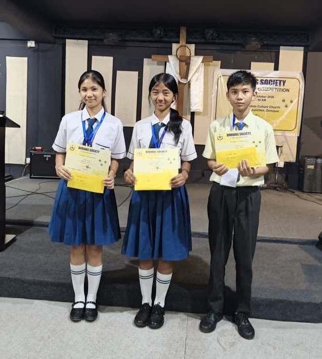 Winner of the 5th Dorians Society Spelling Bee 2026 Ngonle Konyak (Middle) flanked by first runner-up Felix Singh (Right) and second runner-up Jentiren Jamir (Left).